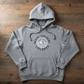 Heather grey pullover hoodie with logo print laid flat on wooden plank background